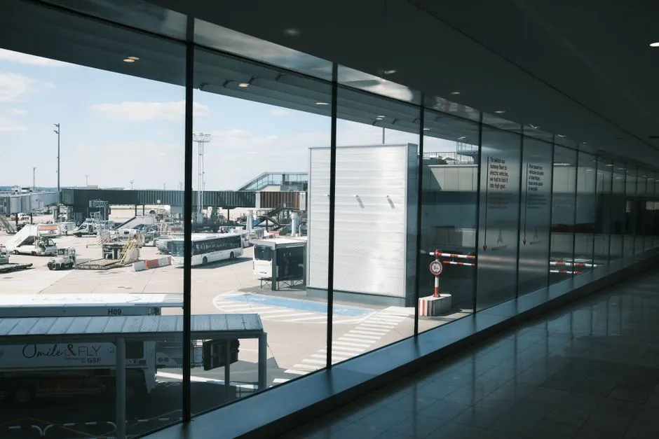 Modern airport terminal interior with a view of the tarmac, illustrative photo